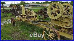 Antique rock crusher on cart tractor or hit miss engine driven